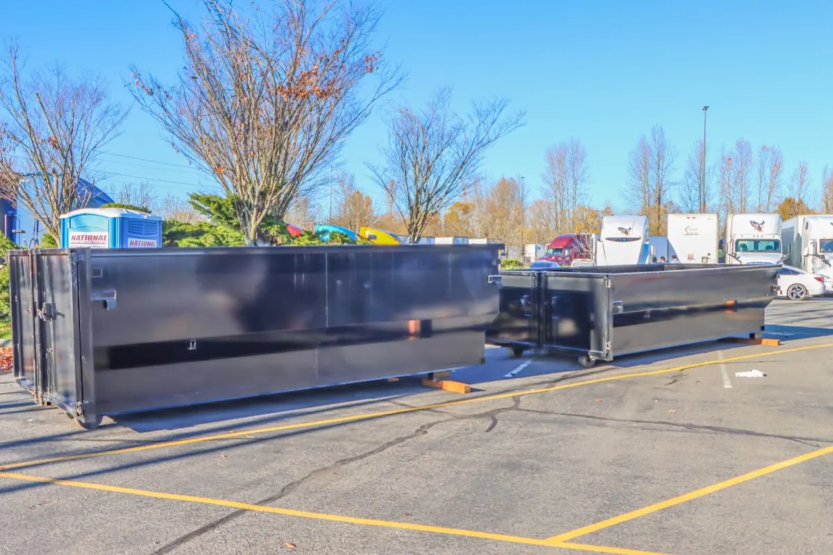 Professional dumpster rental service with roll-off container on residential driveway in Thornbury